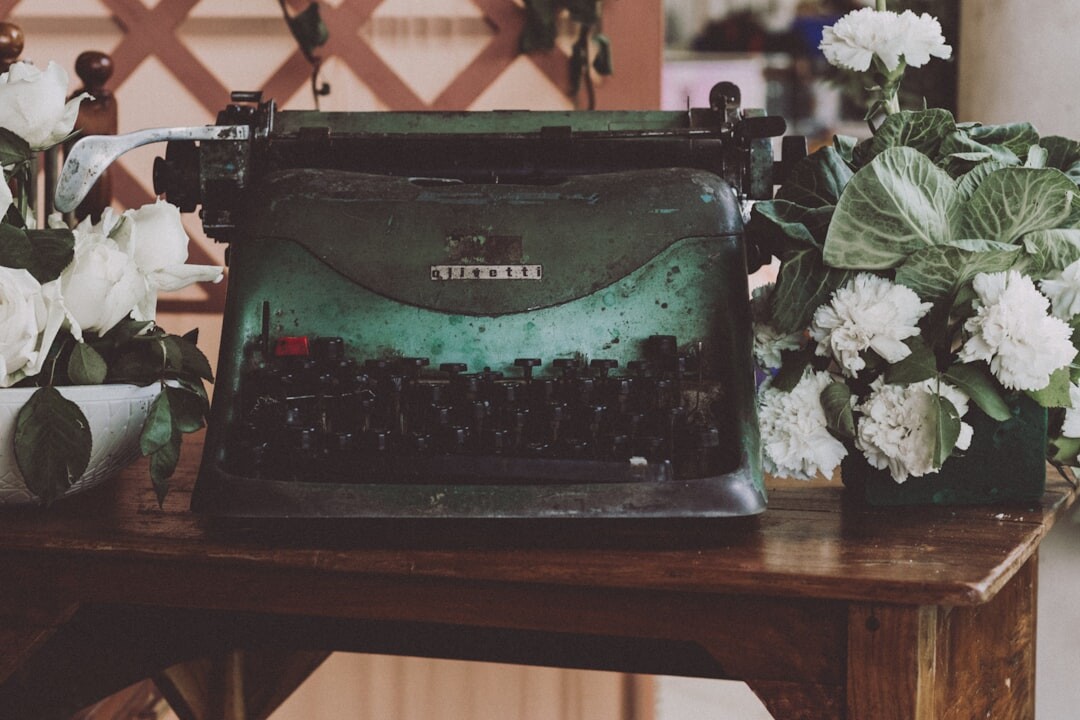 Elegant wooden writing desk with a vintage typewriter and fresh flowers